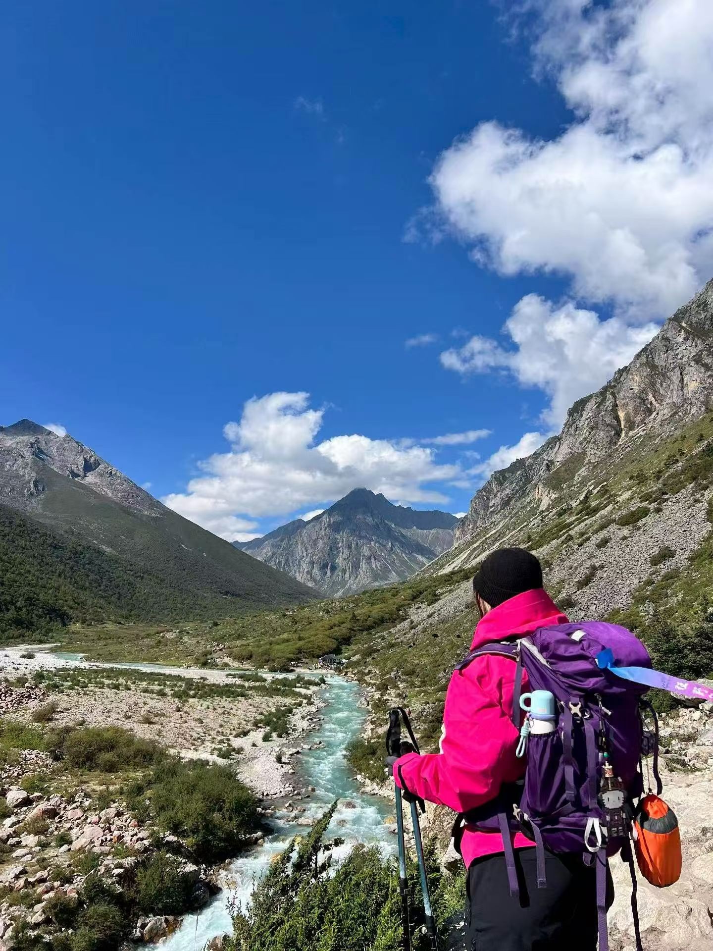 Female hiker overlooking river valley at Le Mando